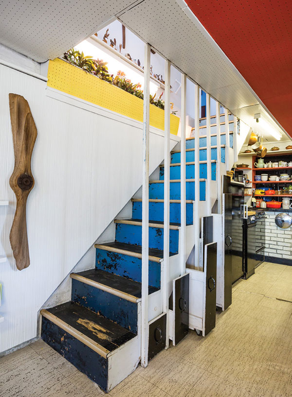 Drawers pull out from under the stairs, one of the functional elements built into the house. | Photography by Jenny Gorman