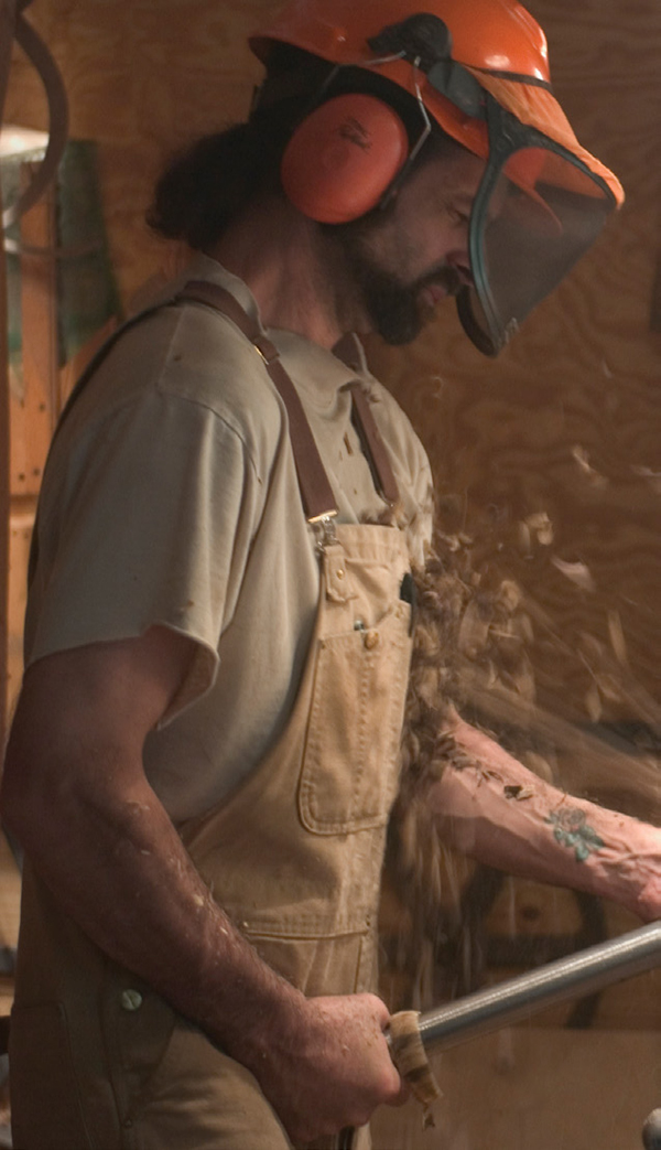 Jim Decrescenzo, who works with Lehrecke, turning a pedestal on a lathe custom made for turning large wet logs into sculptural pedestals and table bases. DAN HOWELL PHOTO