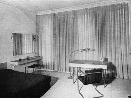 Ruhtenberg’s c. 1937 remodel of this New York town house incorporated furniture by Mies van der Rohe as well as his own furniture designs. Floor-to-ceiling curtains, hung across window walls, were characteristic of Mies van der Rohe and Lilly Reich’s interiors and were used repeatedly by both Johnson and Ruhtenberg. The photograph is from Architectural Forum, July 1937.