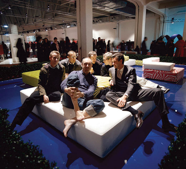 Giulio Cappellini with some of his protégés at Superstudio during Salone del Mobile in Milan in 2001, moving clockwise: Piero Lissoni, Ronan Bouroullec, Carlo Colombo, Erwan Bouroullec, and Jasper Morrison.| COURTESY CAPPELINI
