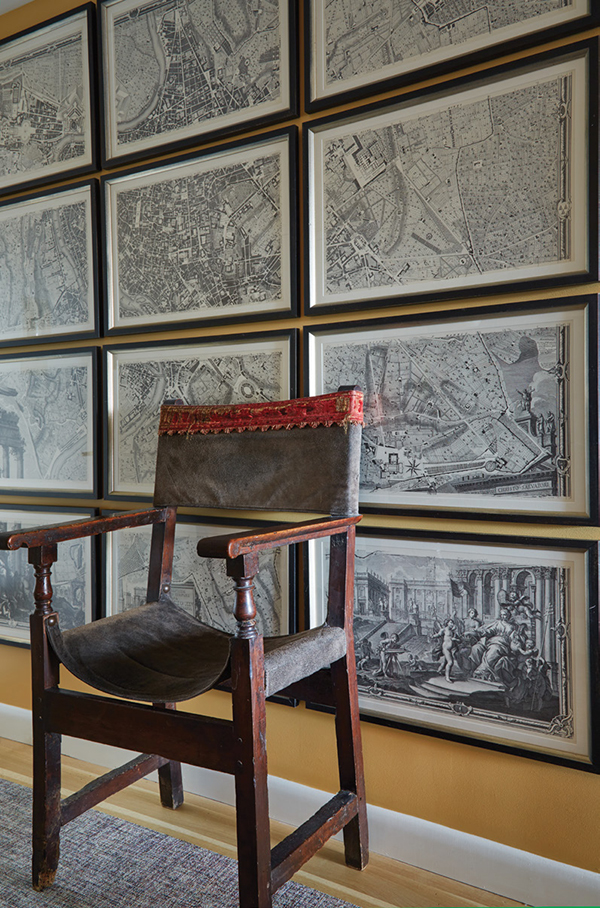 A sixteenth-century Italian armchair stands in front of a reproduction of the twelve-panel iconographic map of Rome by Giambattista Nolli (1748). | Photography by MARK ROSKAMS