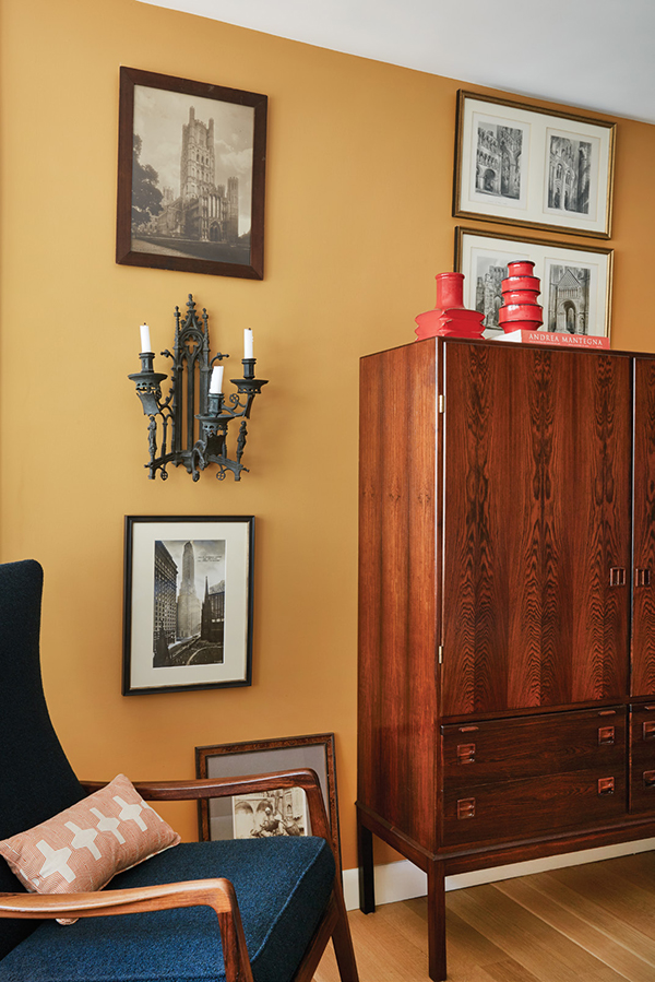 A rosewood cabinet attributed to Niels Otto Møller set a high bar in the search for furniture to complete the interior. At the left hangs a nineteenth century Gothic revival sconce in cast iron. The rocking chair partially visible at the left is attributed to Ole Wanscher. | Photography by MARK ROSKAMS