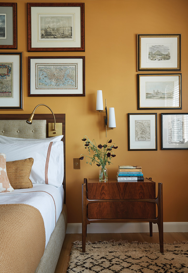 The rosewood bedside table, one of a pair, is by Edmond J. Spence, 1959; the sconce, also one of a pair is by Maison Arlus, 1950. | Photography by MARK ROSKAMS