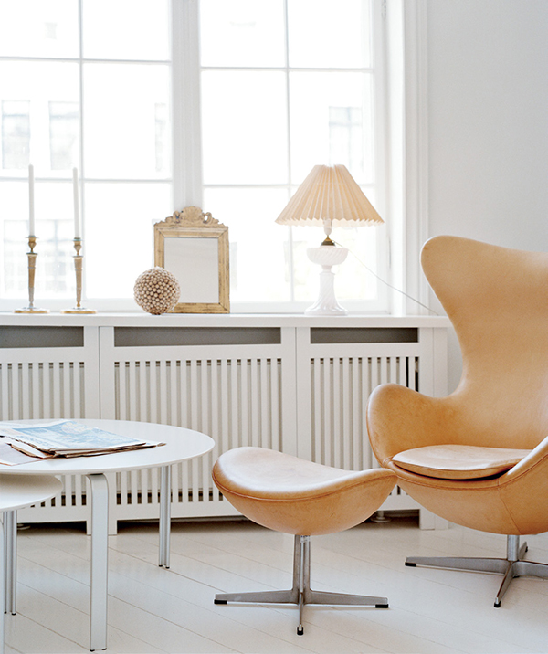 Holm says the Jacobsen Egg chair, in natural leather, bears many spots and stains from the hours his two daughters have spent playing in it. The tables are from the Milan-based De Padova. | Photography by GAELLE LE BOULICAUT