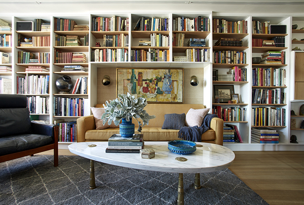 The renovation of this Greenwich Village apartment called for devising bookshelves inspired by those in the Finn Juhl’s house in Denmark. At the left is an armchair by Hans J. Wegner; the marble topped coffee table is by the Monteverdi-Young Furniture Company of Los Angeles. The sofa is a custom design by Bachman Brown Clem. Above it hangs a still life by Jacques Daufin, c. 1955. | Photography by MARK ROSKAMS