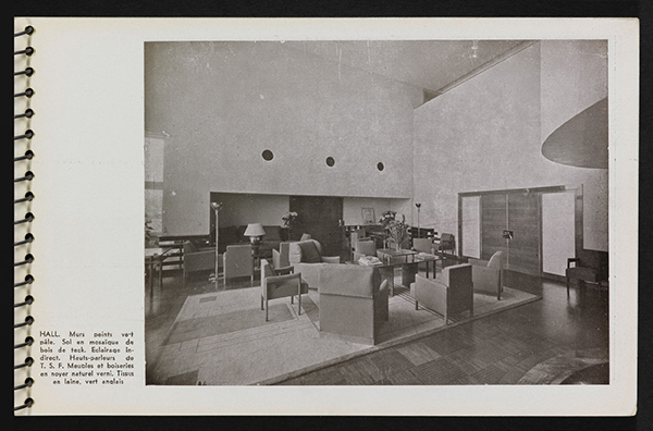 The double-height salon-hall, as seen in a photograph from Une demeure 1934, with an overhanging mezzanine, is complete with a fireside area faced with yellow Siena marble and built-in bench seats. | ROBERT MALLET-STEVENS—ADAGP/©PHILIPPE BERTHÉ-CMN