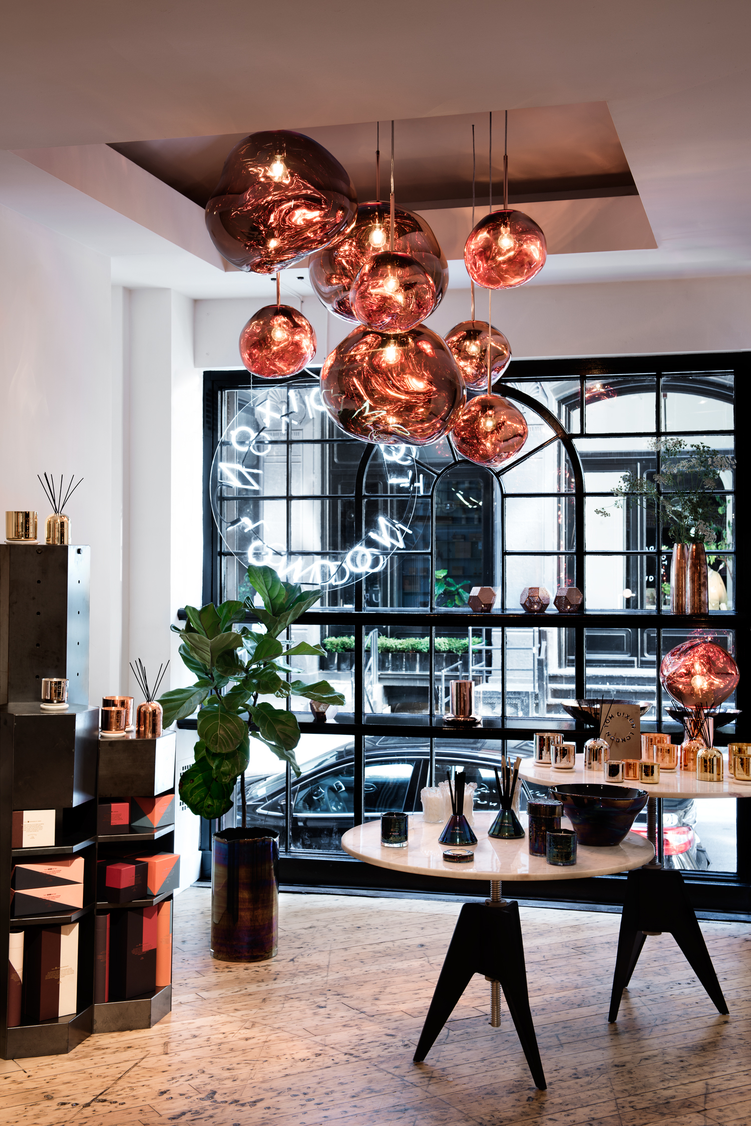 The ground floor of Tom Dixon's New York showroom with mirrored copper pendants and lighting objects. Katie Gibbs, Courtesy of Tom Dixon.