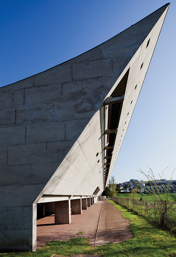 The daring concave roofline of Le Corbusier’s Maison de la Culture (cultural center) in the Site Le Corbusier, Firminy, France. | HUBERT GENOUILLAC/PHOTUPDESIGN, COURTESY FONDATION LE CORBUSIER