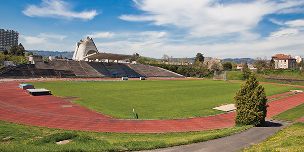The stadium, with the Church of St. Pierre in the background. | HUBERT GENOUILLAC/PHOTUPDESIGN, COURTESY FONDATION LE CORBUSIER