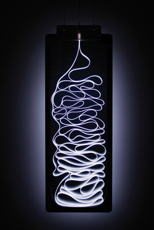 The Getty 451, 2008—inspired by Fahrenheit 451—is a sort of magic mirror. Switched off, it reflects the space and viewer before it. But when turned on, the electroluminescent wire fixed within the reflective Plexiglass appears, creating an apparition of an unraveling coil of paper. | STUDIO MARCUS TREMONTO