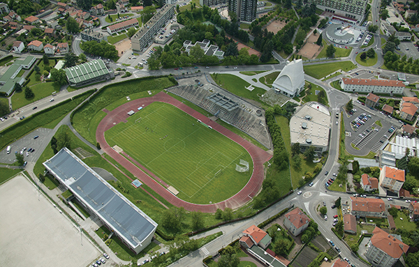 Aerial view of Firminy-Vert, showing the stadium, church, housing unit, cultural center, and surrounding green space. | HUBERT GENOUILLAC/PHOTUPDESIGN, COURTESY FONDATION LE CORBUSIER