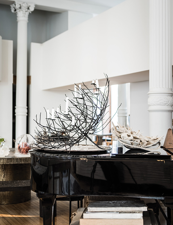 On the lid of a grand piano, the artist has set one of her Burning Bush candelabras beside a collection of plaster casts made from her research drawings of sea life. It’s her practice to save material scraps from her workshop, repurposing them for other projects. | SASHA MASLOV PHOTO
