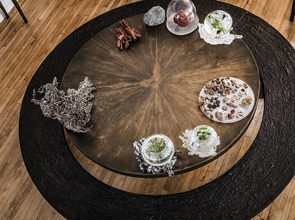 From the apartment’s mezzanine, one can look down on the bronze Radiant table Oka Doner designed in 1995 and the Ice Ring bench that surrounds it like a planetary ring. Around the perimeter, she’s arranged several hand-blown and etched glass pieces she made for Steuben as well as red wax casts she refers to as “hands,” and a tangle of sterling silver that resembles table coral. | SASHA MASLOV PHOTO