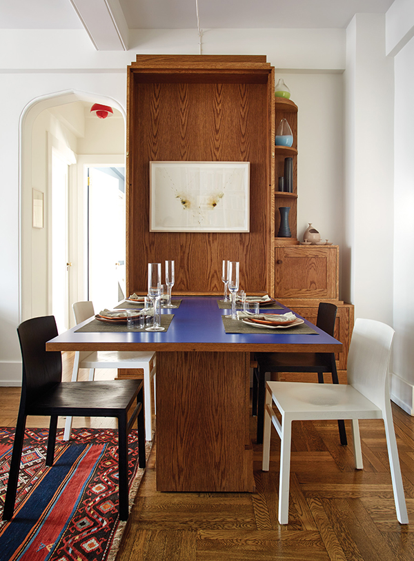 Like a Murphy bed, the hinged table unfolds to create seating for eight with an additional hidden leaf. Littman worked closely on the concept with Patrick Keesey Furniture & Design. Inside the cabinet hangs Study for 110 by Marco Breuer. | Photography by MARK ROSKAMS
