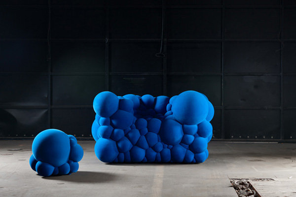 Inspired by images of cells dividing and multiplying, the Mutations series includes this royal blue club chair and square stool (2012), assembled from molecule-like foam spheres of various sizes. | Nico Neefs Photo