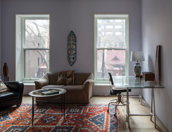 Soft light from the street comes through double- hung windows in the triplex.