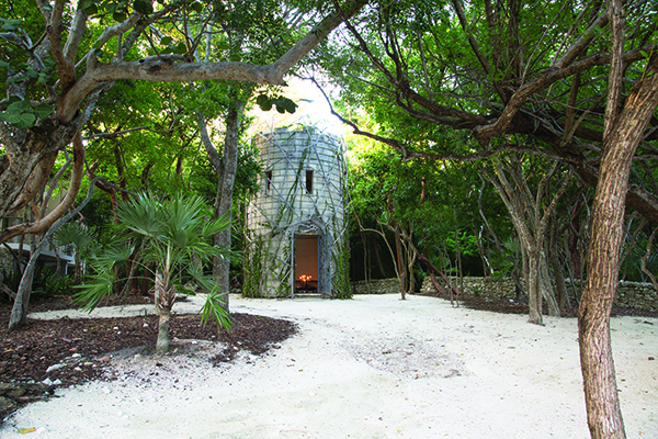 Michele Oka Doner’s Shaman’s Hut converted a 1936 hurricane shelter into a place of spiritual refuge. The exterior is wrapped in vines and epiphytes attached to a trellis.