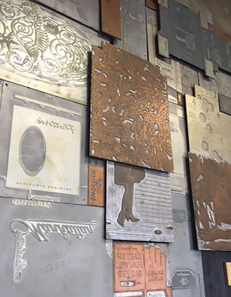 Metal printing plates from some of the original CCA ads still hang in the lobby of the former CCA building. MICHAEL CARLEBACH PHOTO