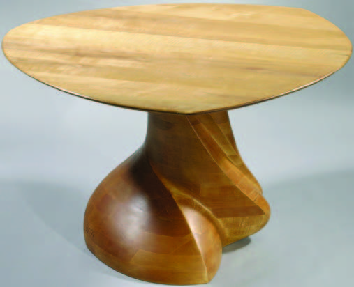 This dining table by Wendell Castle in stack laminated cherry, 1976, is at Moderne Gallery. MODERNE GALLERY